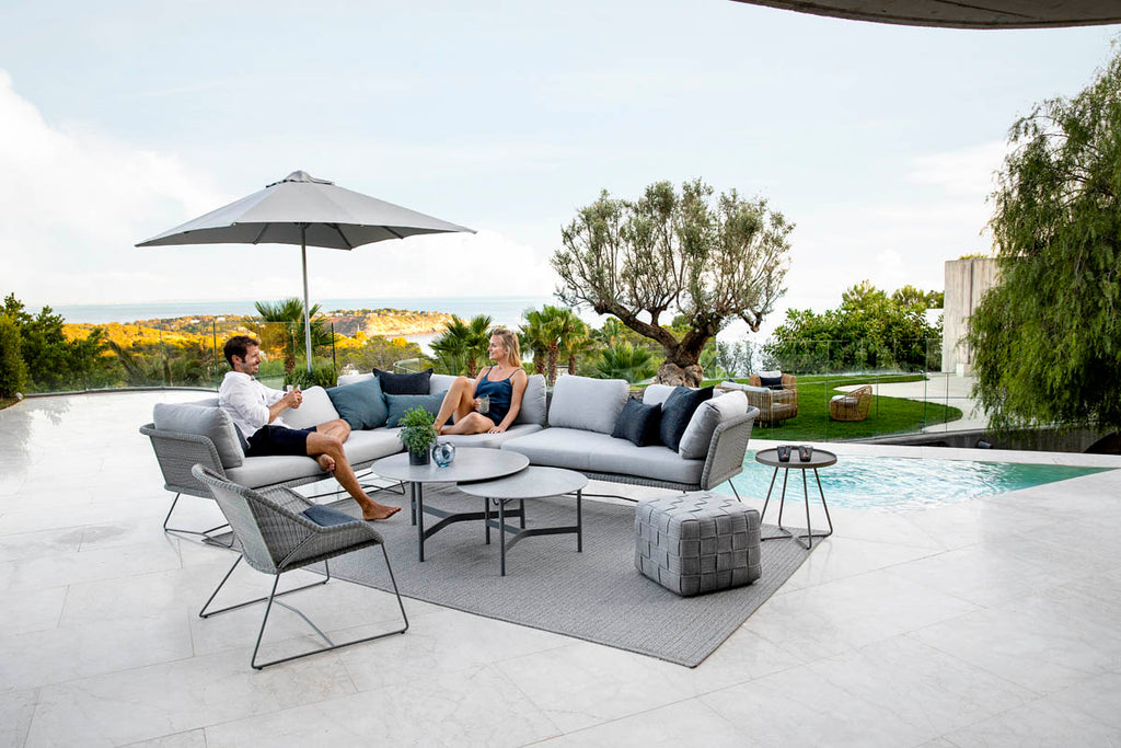 Modern lounge area with spacious and elegant outdoor lounge sofa and modern coffee tables 