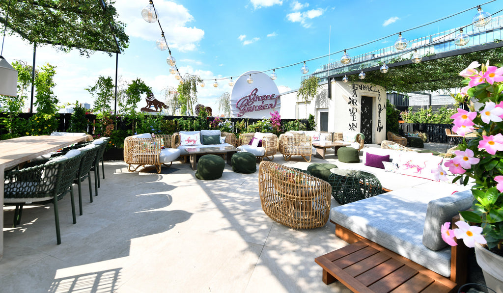 Rooftop bar lounge Grace Garden, green outdoor chairs, Nest lounge chairs, green plants, blooming flowers