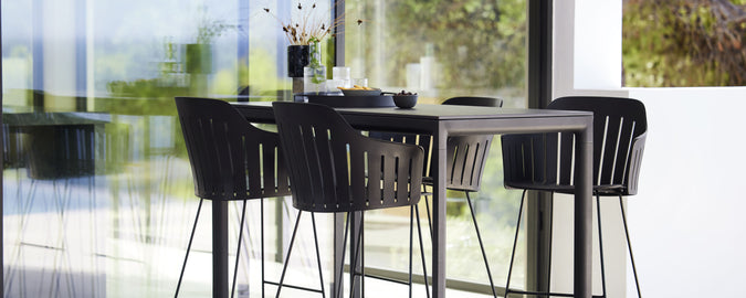 Moderne barbord med matchende barstoler, med slank design og minimalistisk estetikk, perfekt for sosiale sammenkomster og avslapning.