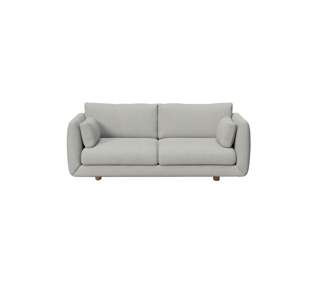 Lys grå moderne sofa med runde puter i et minimalistisk design.