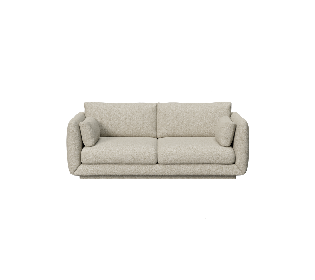 Lys brun sofa med runde puter i moderne design.