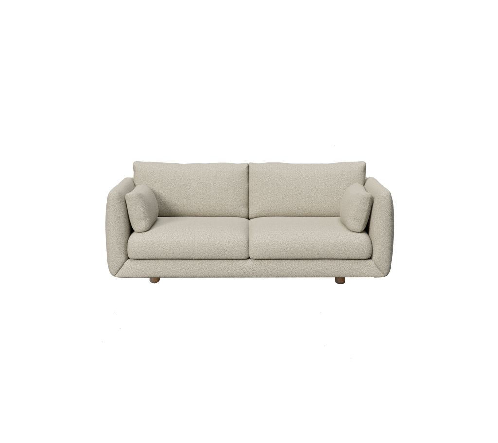 Lys brun moderne sofa med runde puter i en minimalistisk stil.