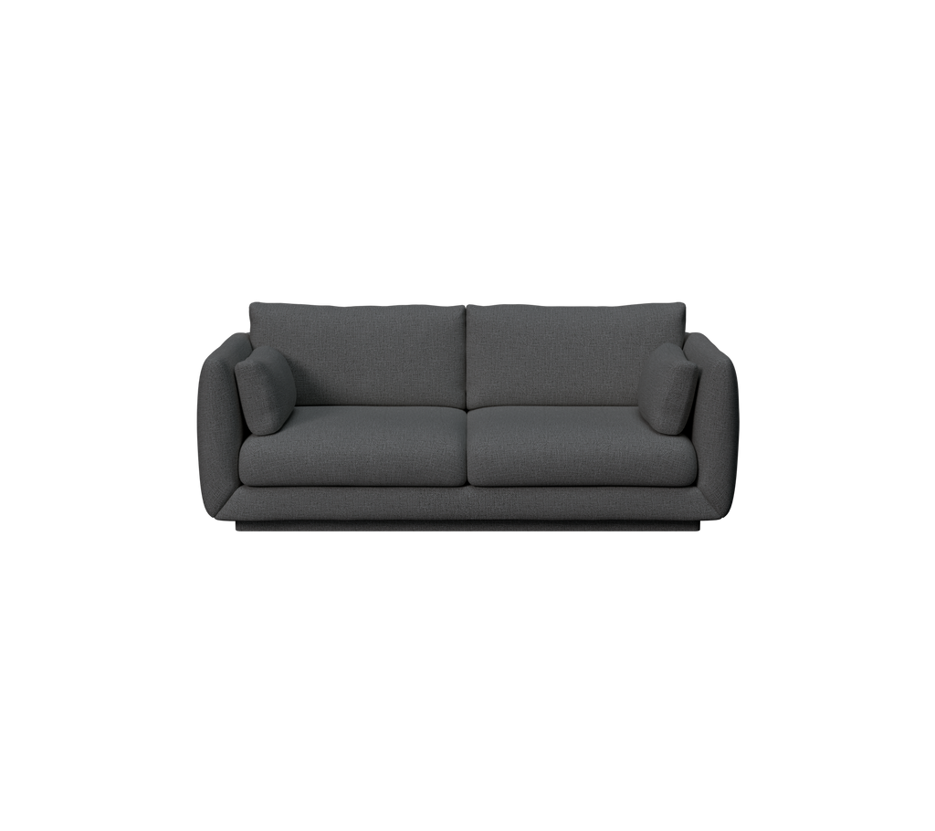 Moderne mørkegrønn sofa med puter.