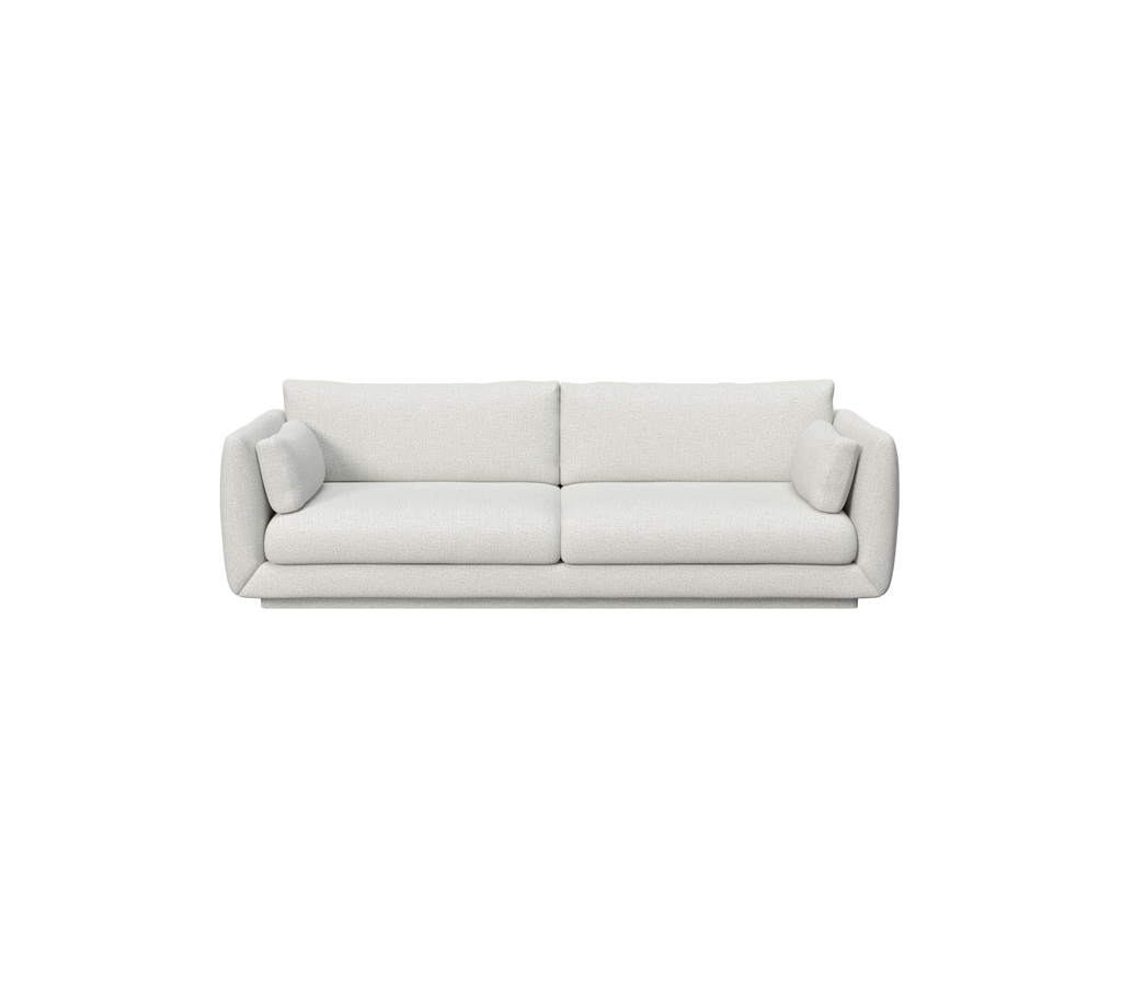 Lys grå sofa med to runde puter i moderne design.