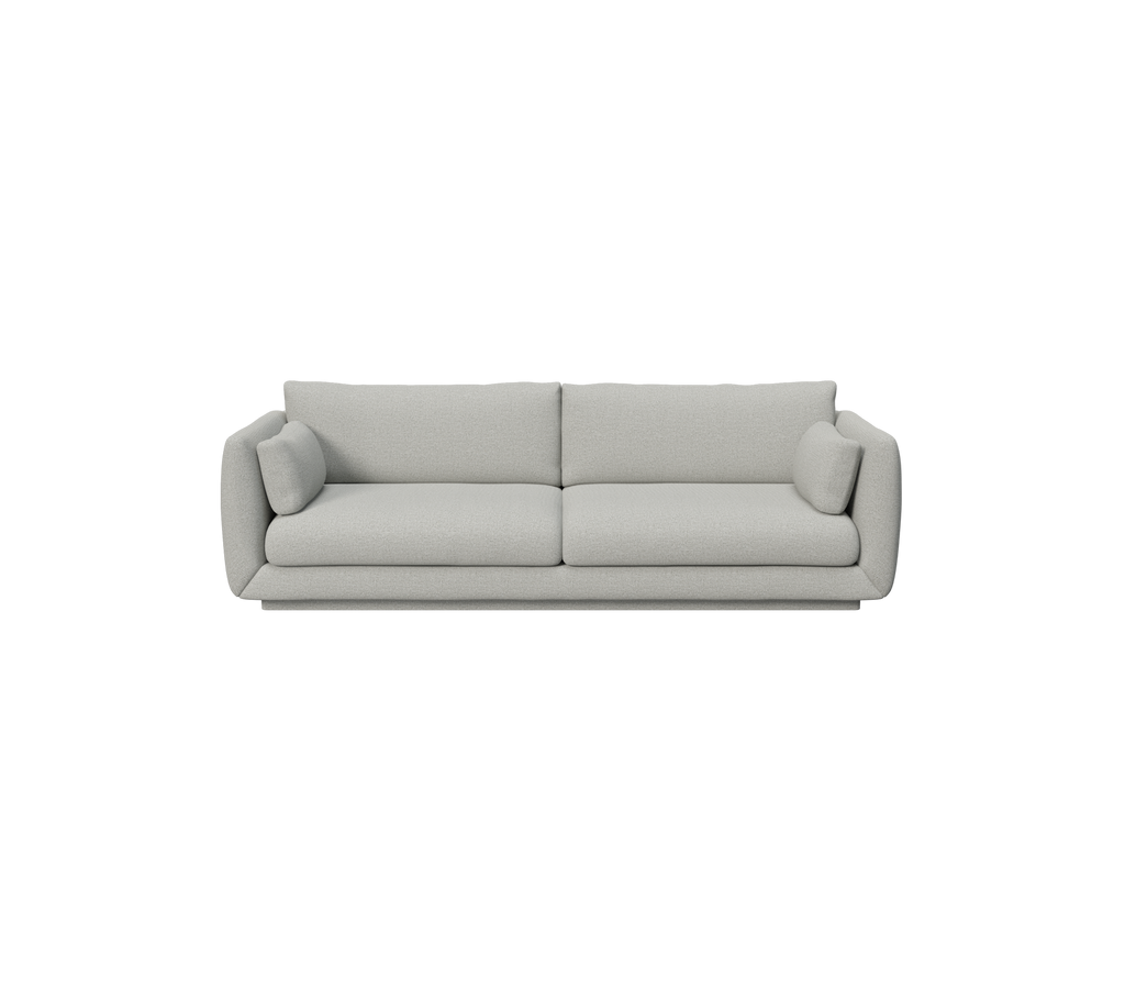 Lys grå moderne sofa med runde puter.