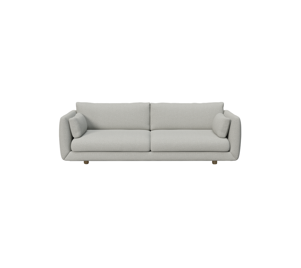 Lys grå moderne sofa med runde puter.