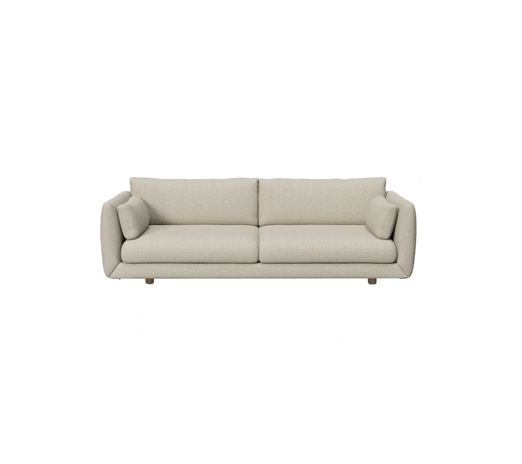 Moderne lysebrune sofa med runde puter i minimalistisk design.