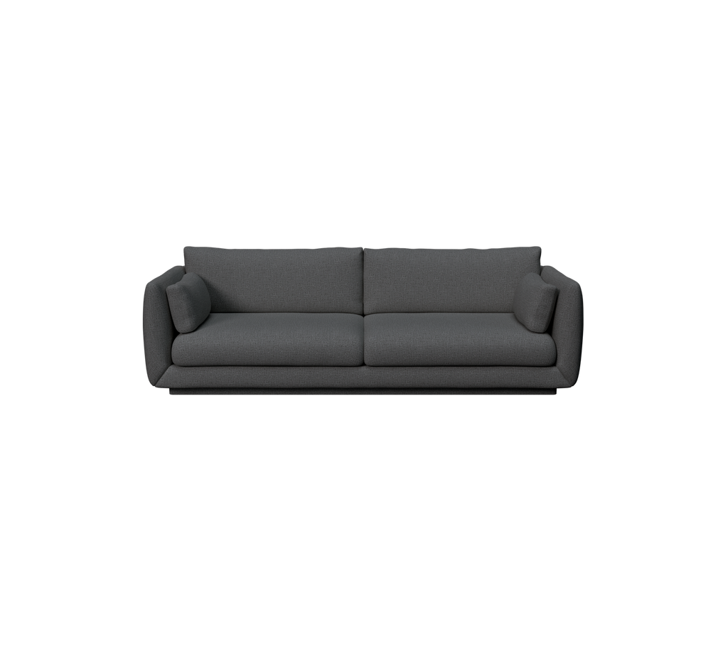 Moderne mørkegrønn sofa med et strømlinjeformet design og komfortable puter.