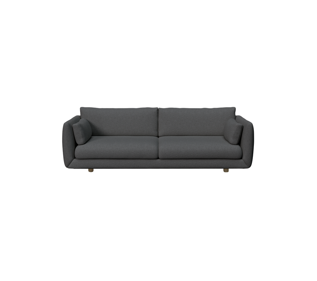 Mørkegrønn moderne sofa med myke puter.