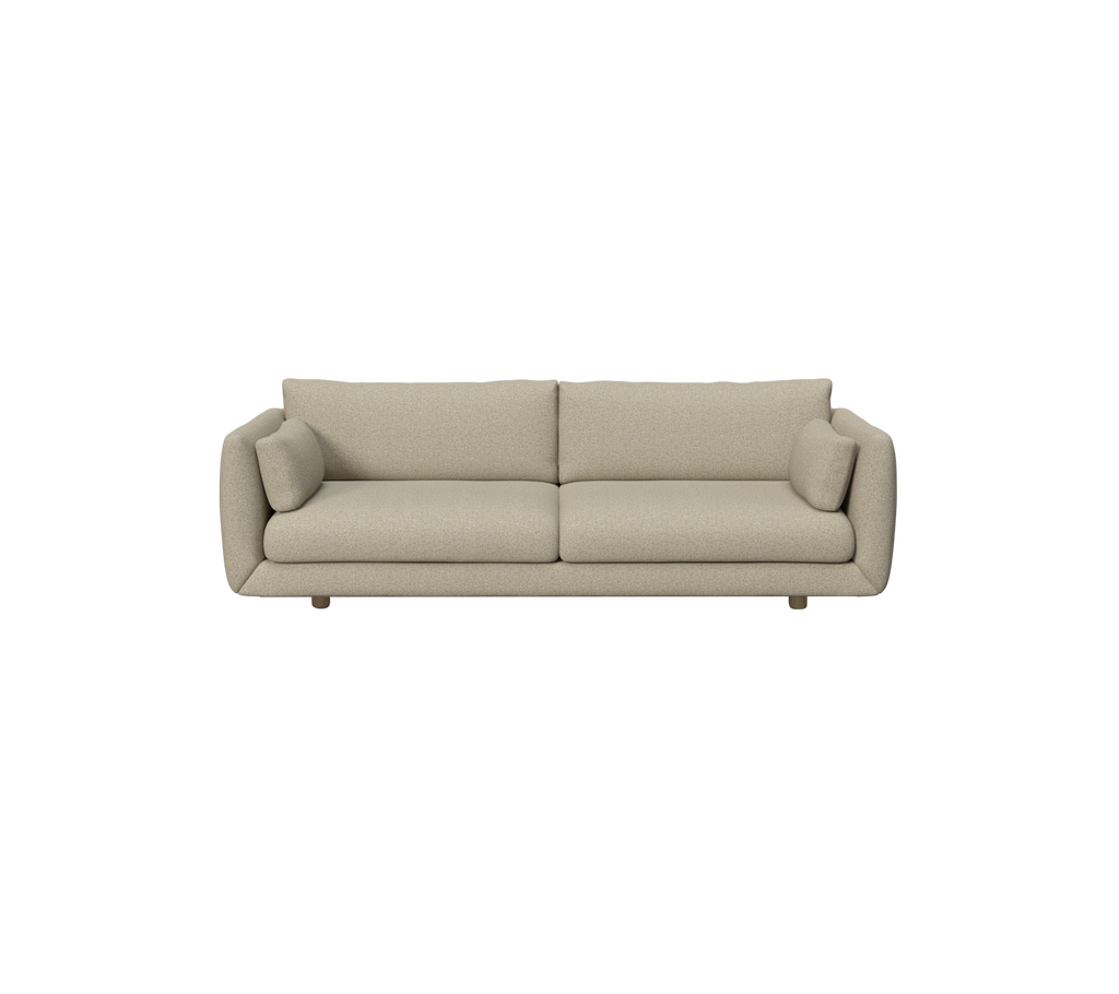 Brun moderne sofa med runde puter i en moderne setting.