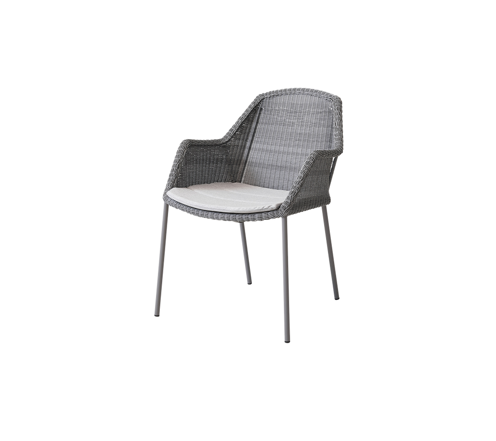 Stylish gray woven chair with a comfortable white cushion, perfect for adding modern flair to any space.